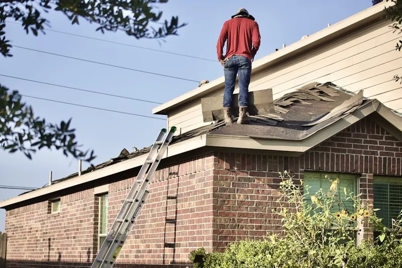 Professional roofer working on a residential roof in Terre Haute